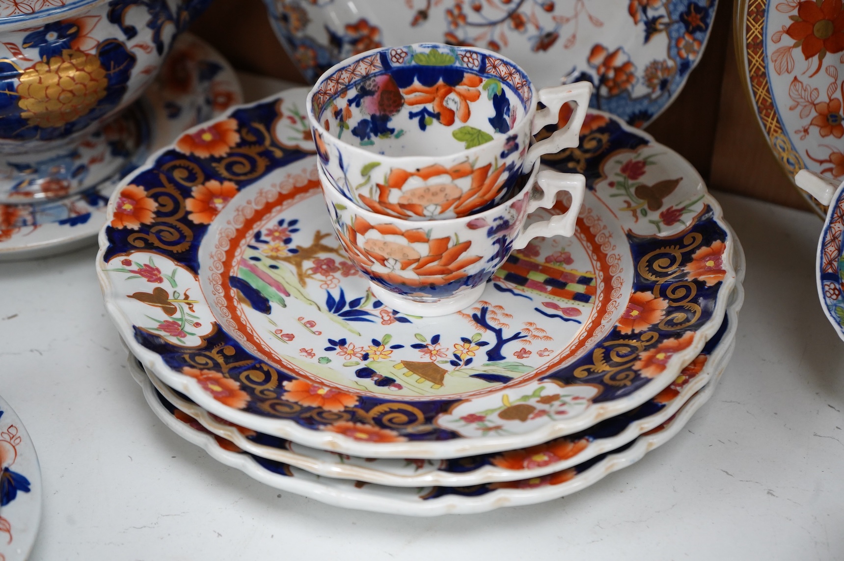 A collection of 19th century English ironstone china to include two pairs of sauce tureens, covers and stands, one marked Masons, various side plates and teacups
